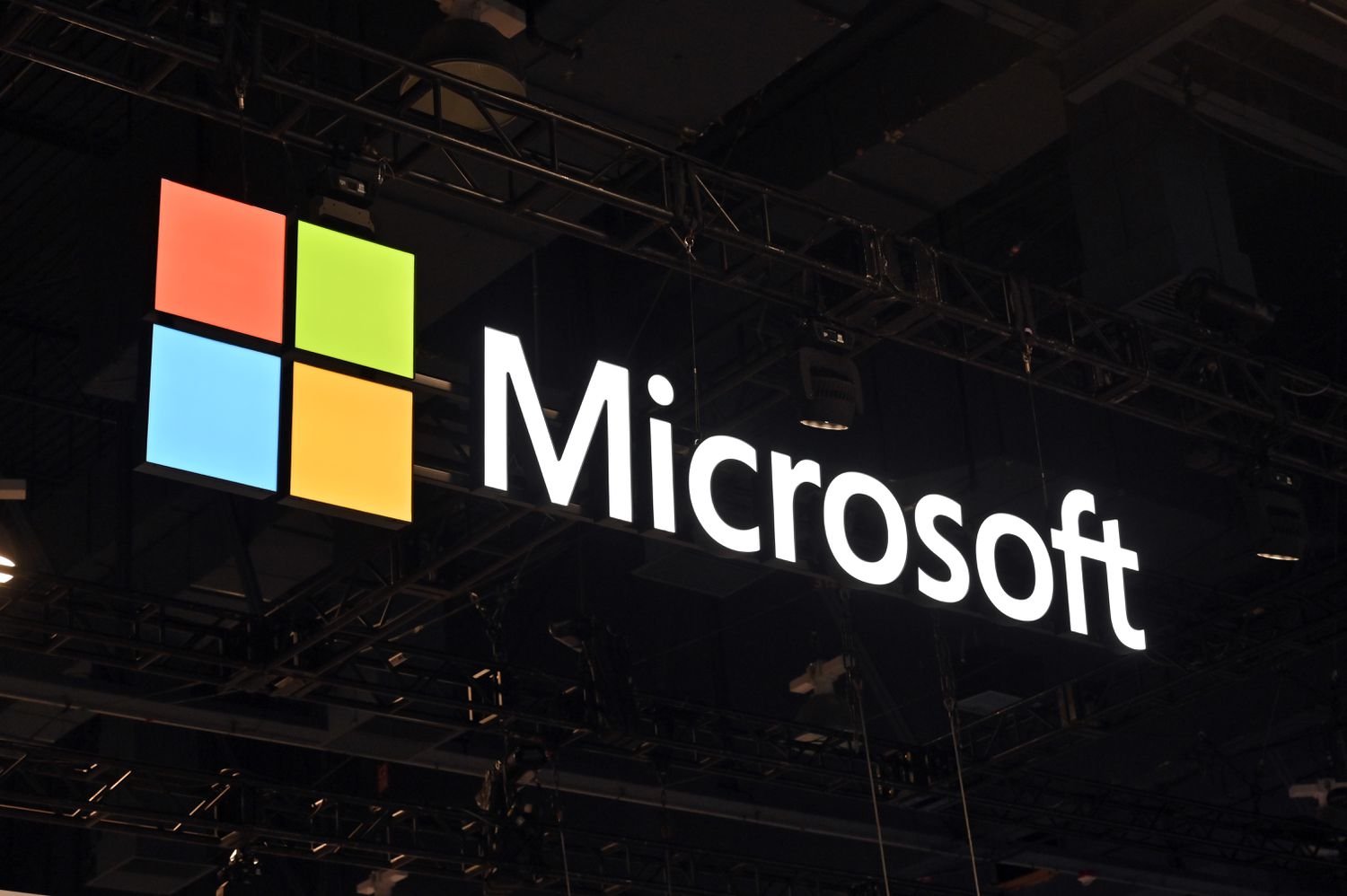 The Microsoft logo glows on a sign.