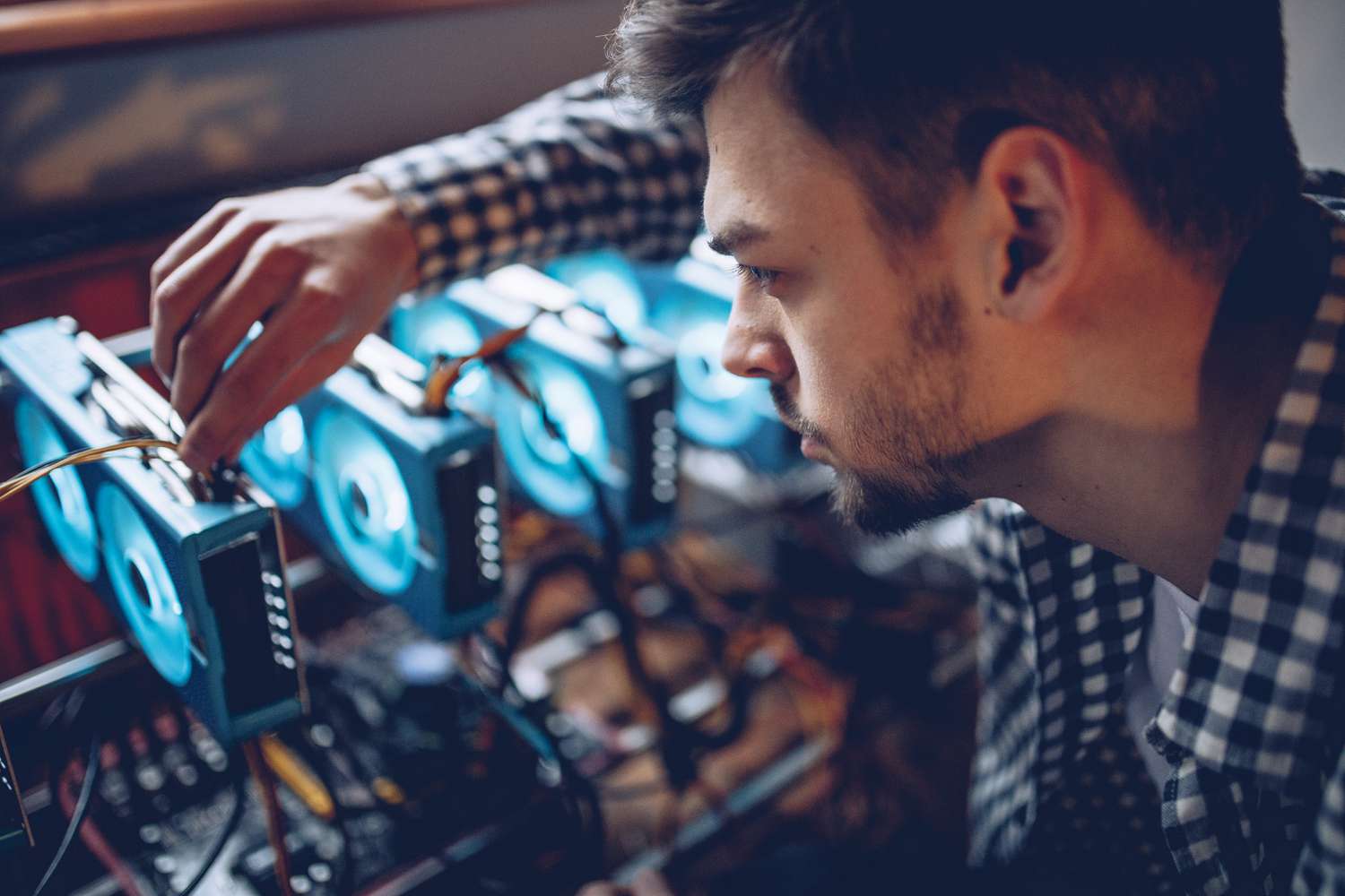 Person preparing a mining rig for cryptocurrency mining