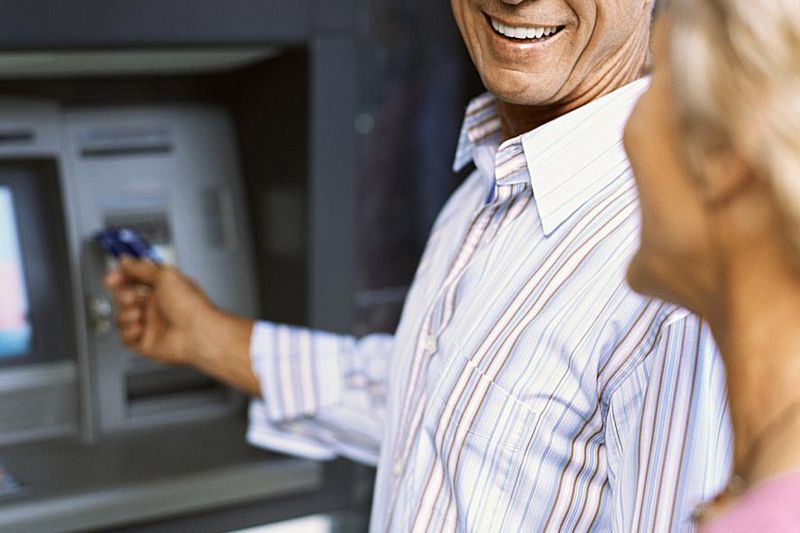Older couple withdrawing money from an ATM