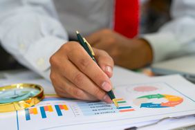 A businessman analyzing investment charts.