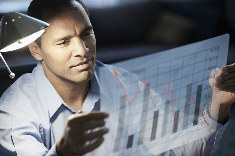 Businessman looking at bar graph