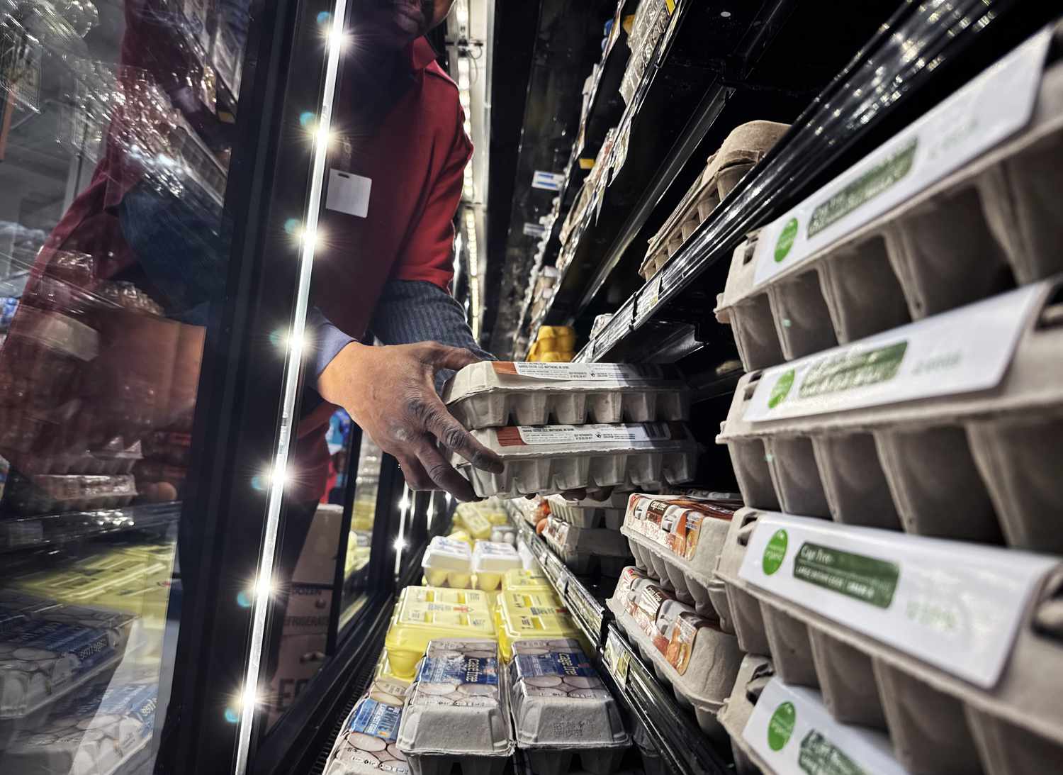 A worker stocks eggs at a grocery store in Washington, D.C., on Wednesday, February 12, 2025. 