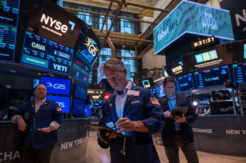 Traders work the floor of the New York Stock Exchange on May 13, 2025. 
