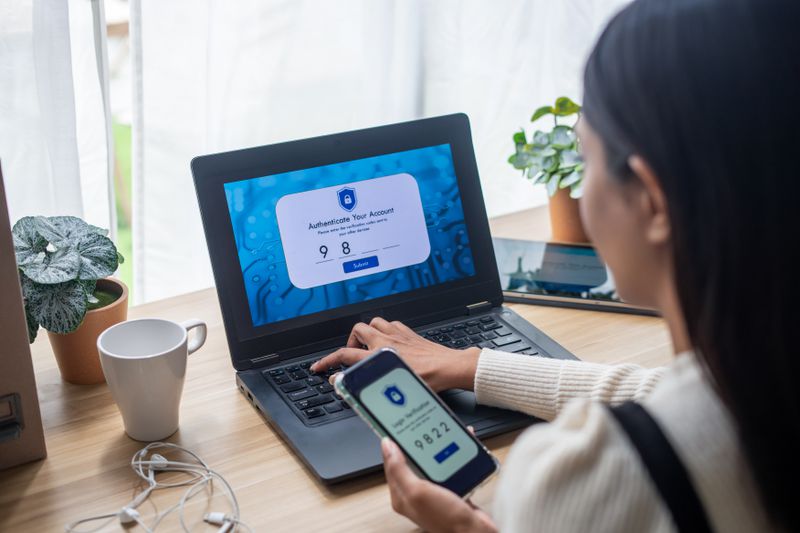 A person using two factor authentication on laptop to prevent online identity thief.