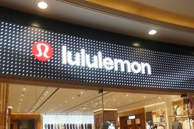 The Lululemon logo is seen above the entrance to a store.