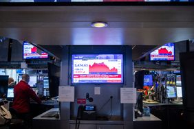 A television station broadcasts stock market news on the floor of the New York Stock Exchange.