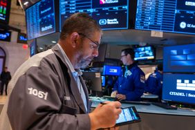 Traders work on the floor of the New York Stock Exchange (NYSE) on October 22, 2024 in New York City