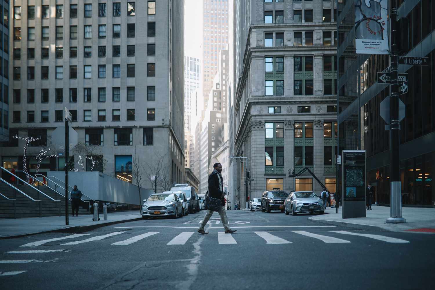 A man crossing a street in Manhattan