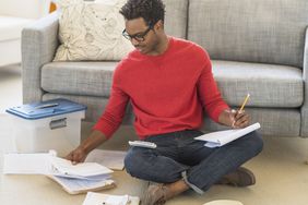 man on floor with tax forms