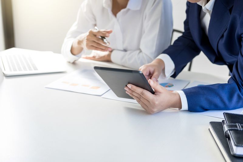 Business colleagues working in office using a tablet.