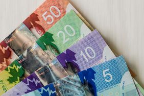 Canadian money. Dollar banknotes on wooden background.