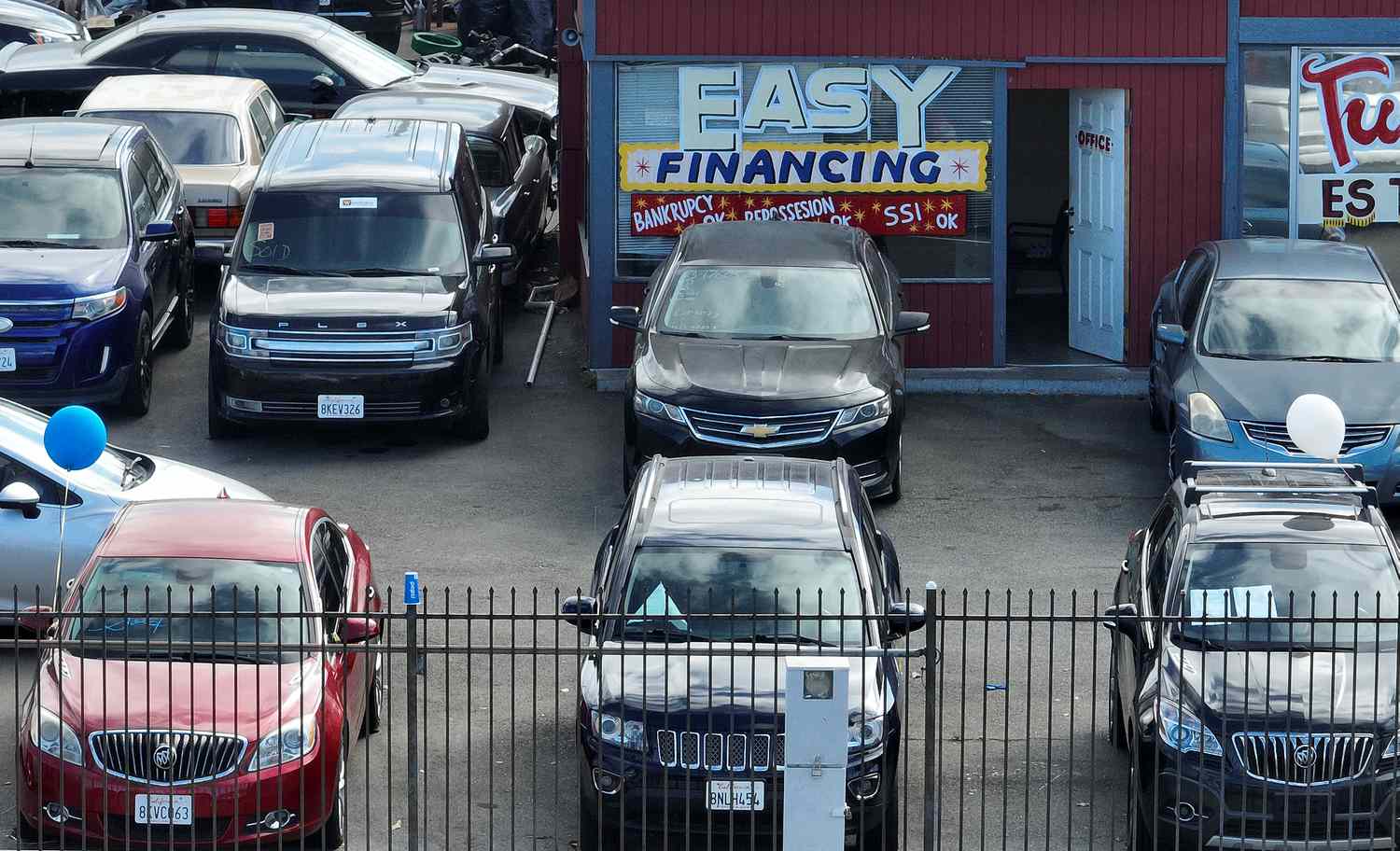 Cars are parked in a lot. 