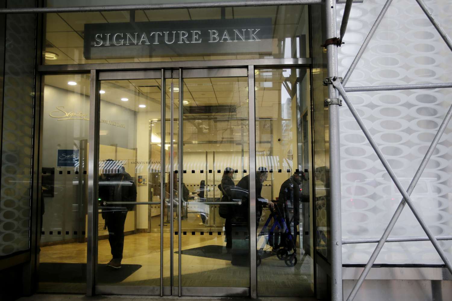 NEW YORK, NEW YORK - MARCH 13: People wait inside the Signature Bank branch on March 13, 2023 in New York City. Signature Bank a $110 billion commercial bank with offices in California, Connecticut, Nevada, New York and North Carolina, was closed by Regulators on Sunday the customers alarmed by SVB yanked their funds.