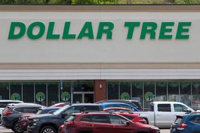 Cars and trucks are seen in front of a Dollar Tree store.