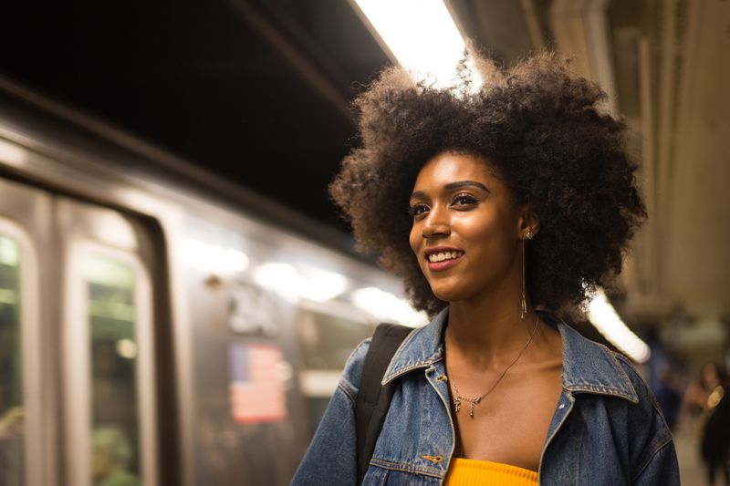 Woman taking subway train in New York City. 