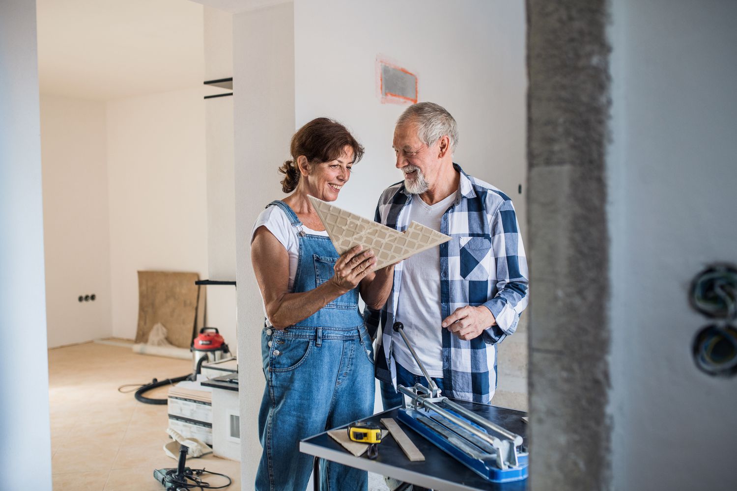 A couple review material for a home construction project.