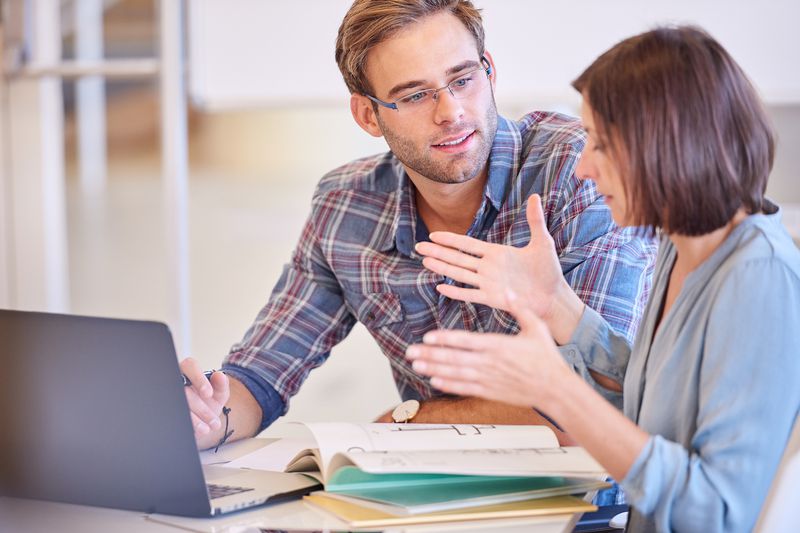 A financial advisor explains how a FICO credit score is calculated to a young person who wants to buy a home.