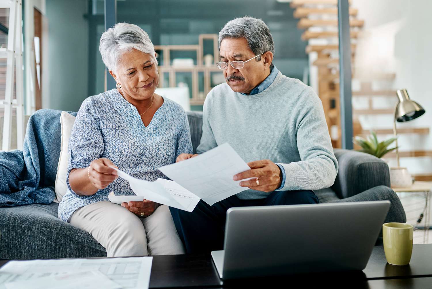 Two people going through paperwork together at home