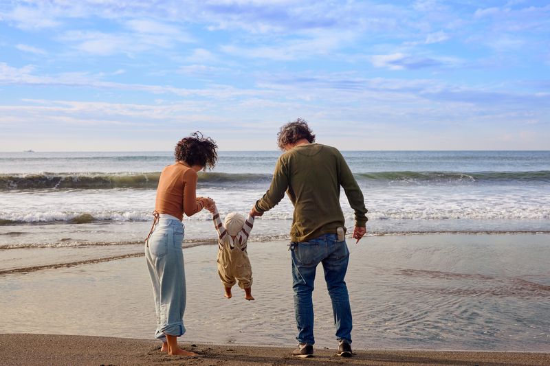 Young Couple on Beach with Baby
