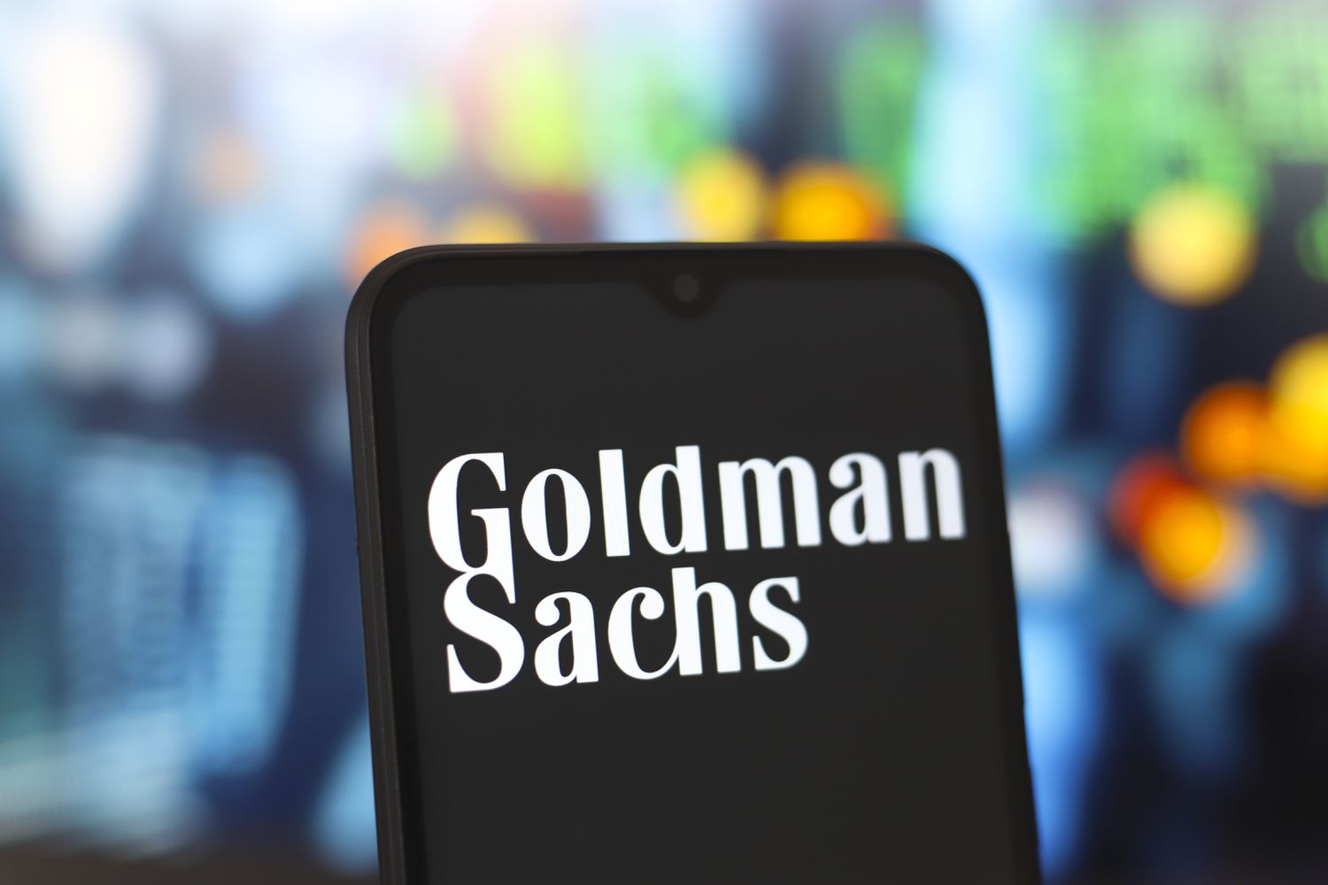 The Goldman Sachs logo is seen on the screen of a smartphone.