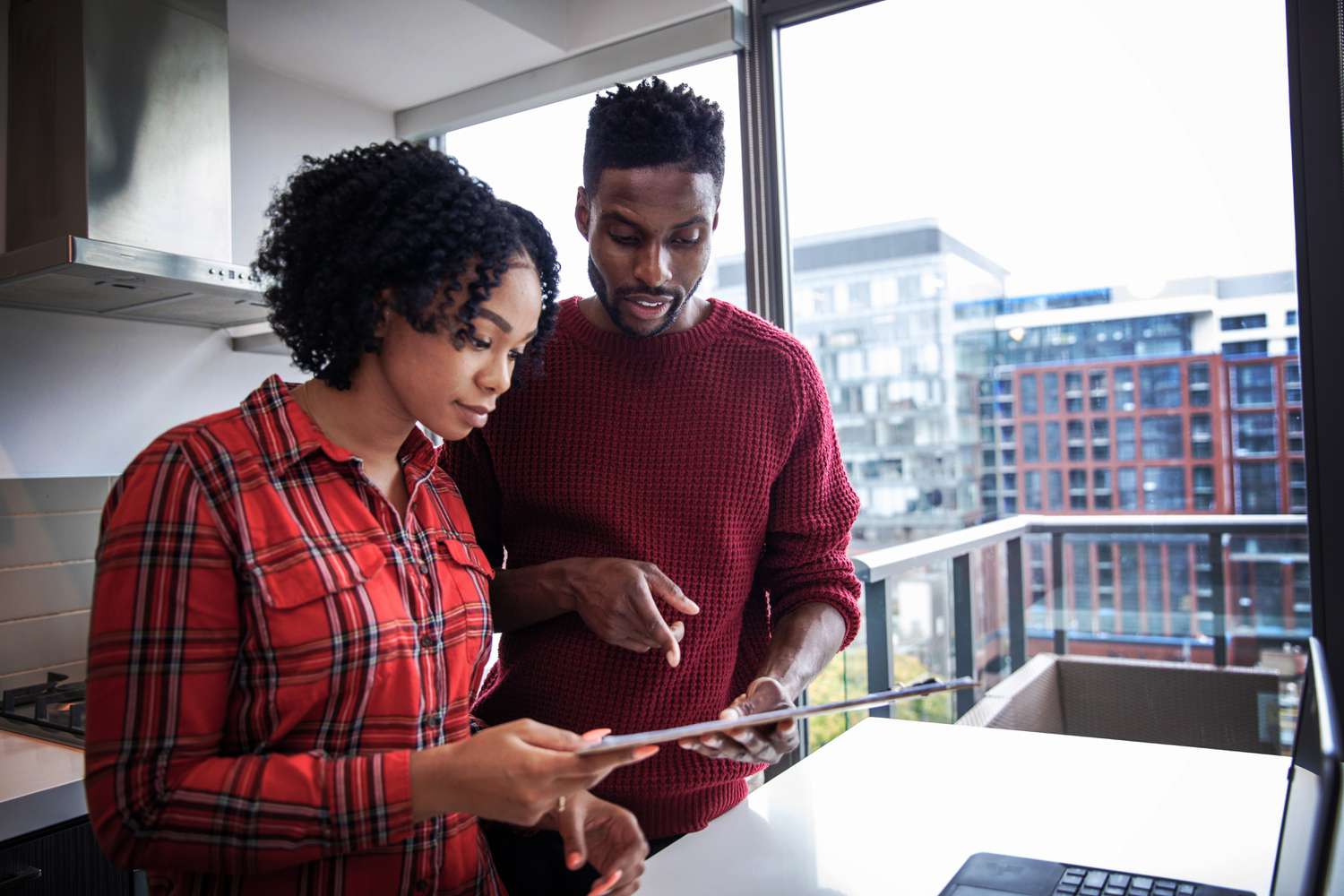 A couple researchin small business bank accounts for their business.