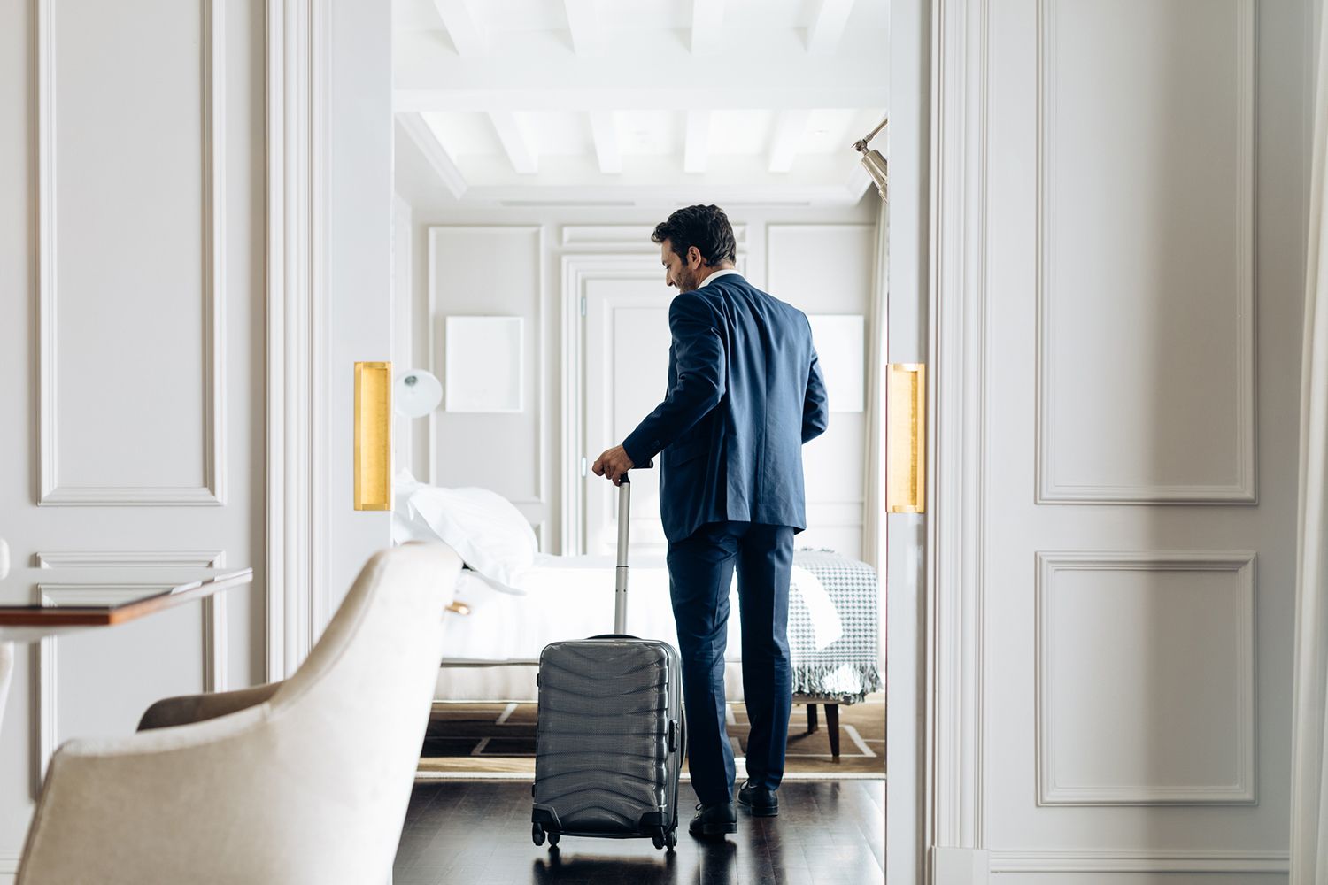 Businessman With Wheeled Luggage in Suite