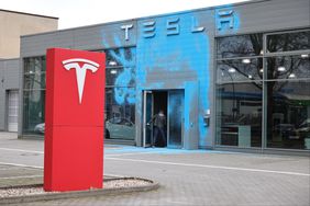 A Tesla car dealership stands doused in blue paint following vandalism by activists of the group New Generation on March 31, 2025 in Berlin, Germany