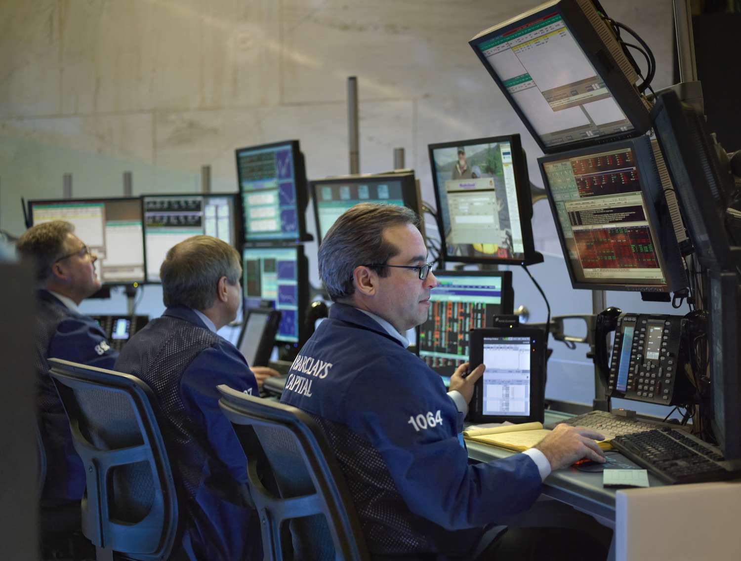 Traders working in front of banks of computers
