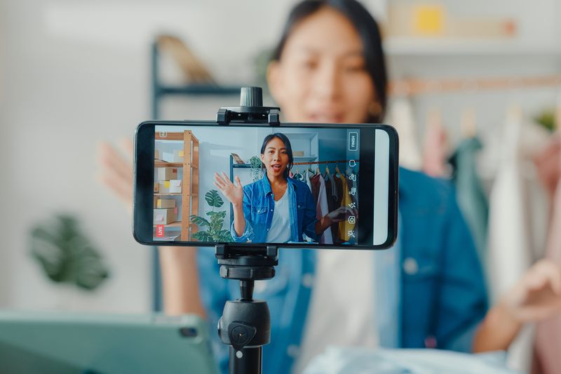 Woman recording herself at home on phone