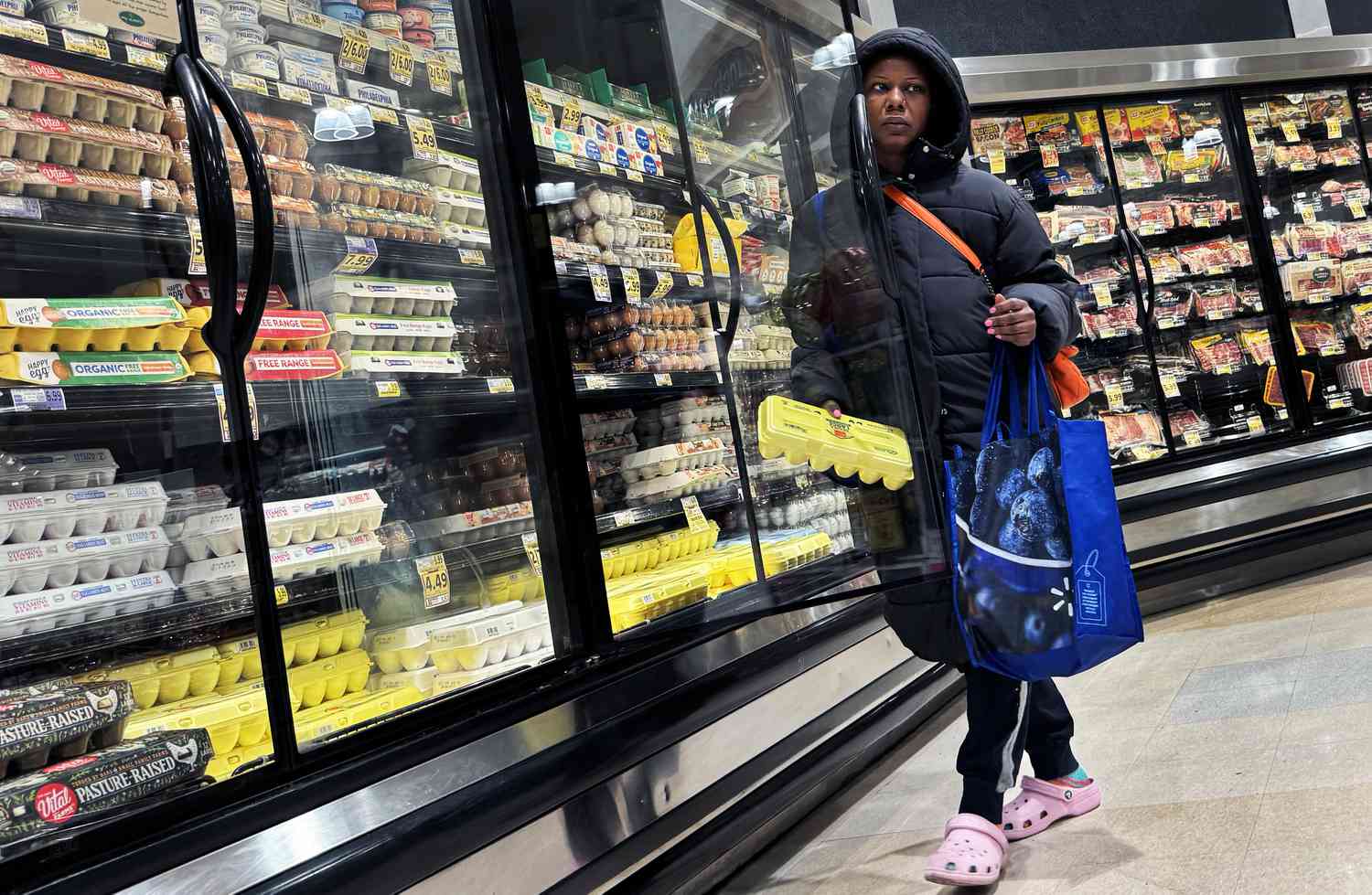 A shopper takes a carton of eggs from the cooler in a grocery store in Washington, D.C., on Saturday, April 6, 2024. 