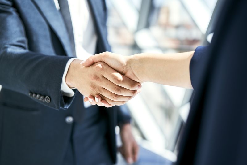 Close-up of handshake of businesswoman and businessman.