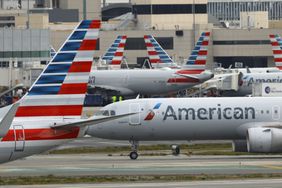 Several American Airlines planes are seen at an airport.