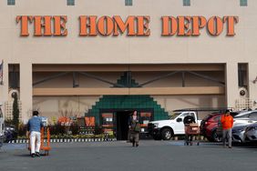 People and cars are seen in front of a Home Depot store.