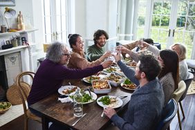Parents and children toasting in a family dinner.