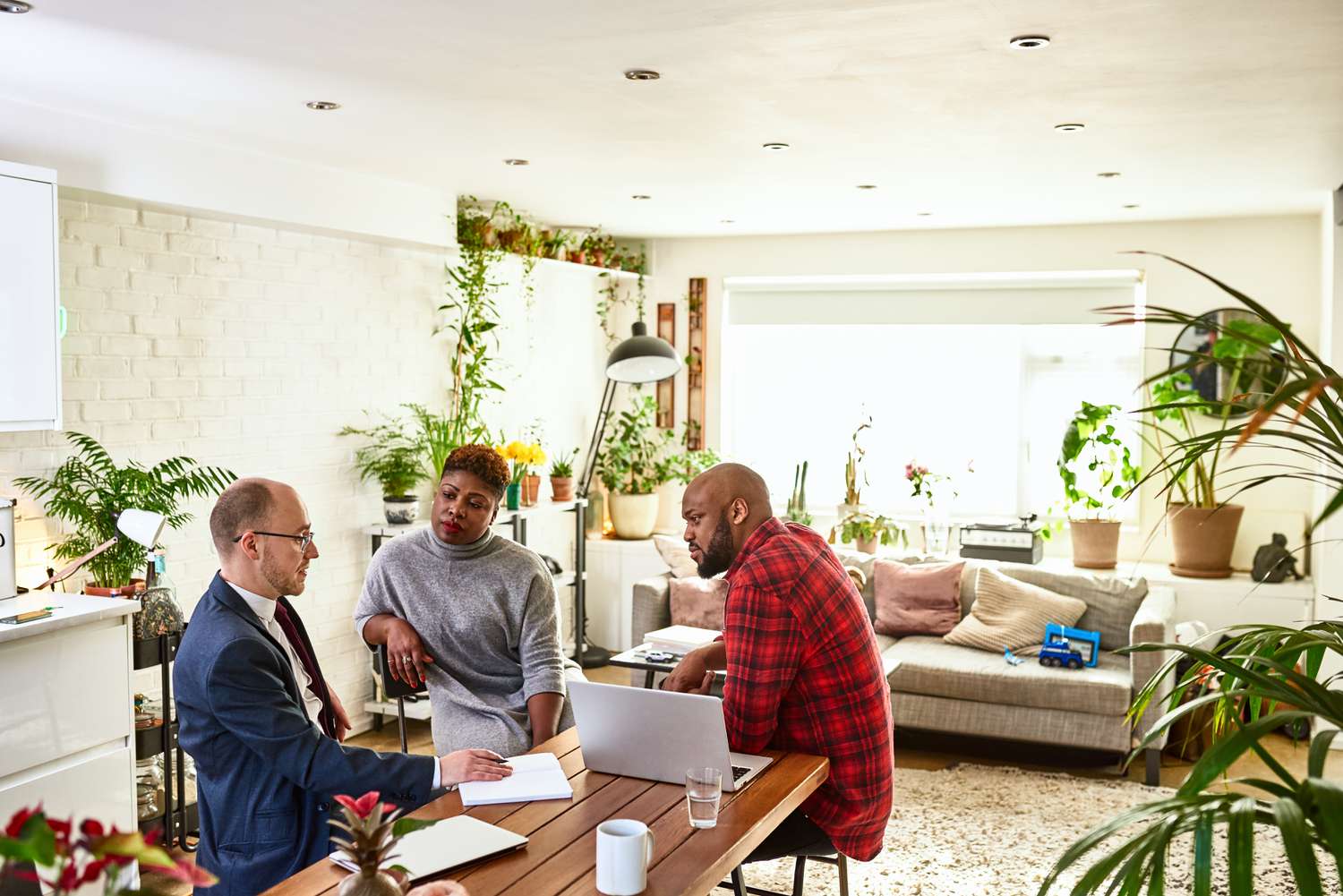 A couple discussing getting a FAIR Plan policy for their home with the agent.