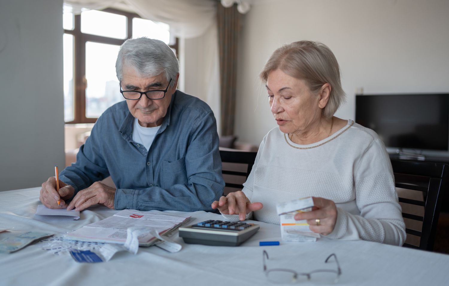 Couple discussing finances with a calculator