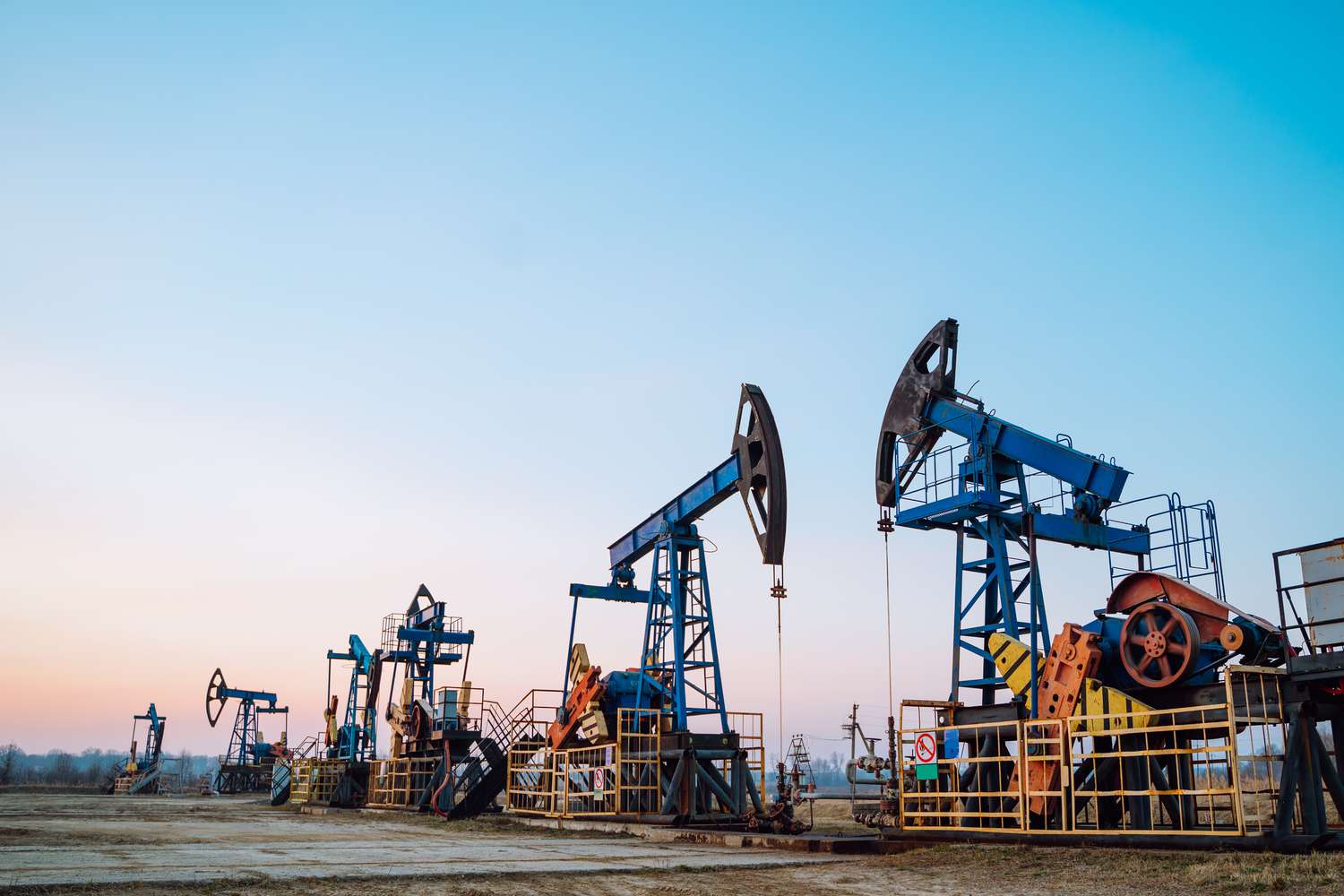 A row of oil pumps in an oil drilling field in Siberia. 