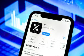The Apple App store page for X, formerly Twitter, is seen on a phone screen in front of a blue backrgound.