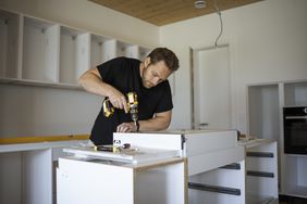 A man remodels a kitchen