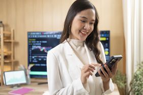 A crypto trader accesses crypto wallet on mobile phone.