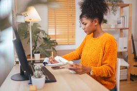 Young adult calculating budget and adjusting tax withholding for the year.