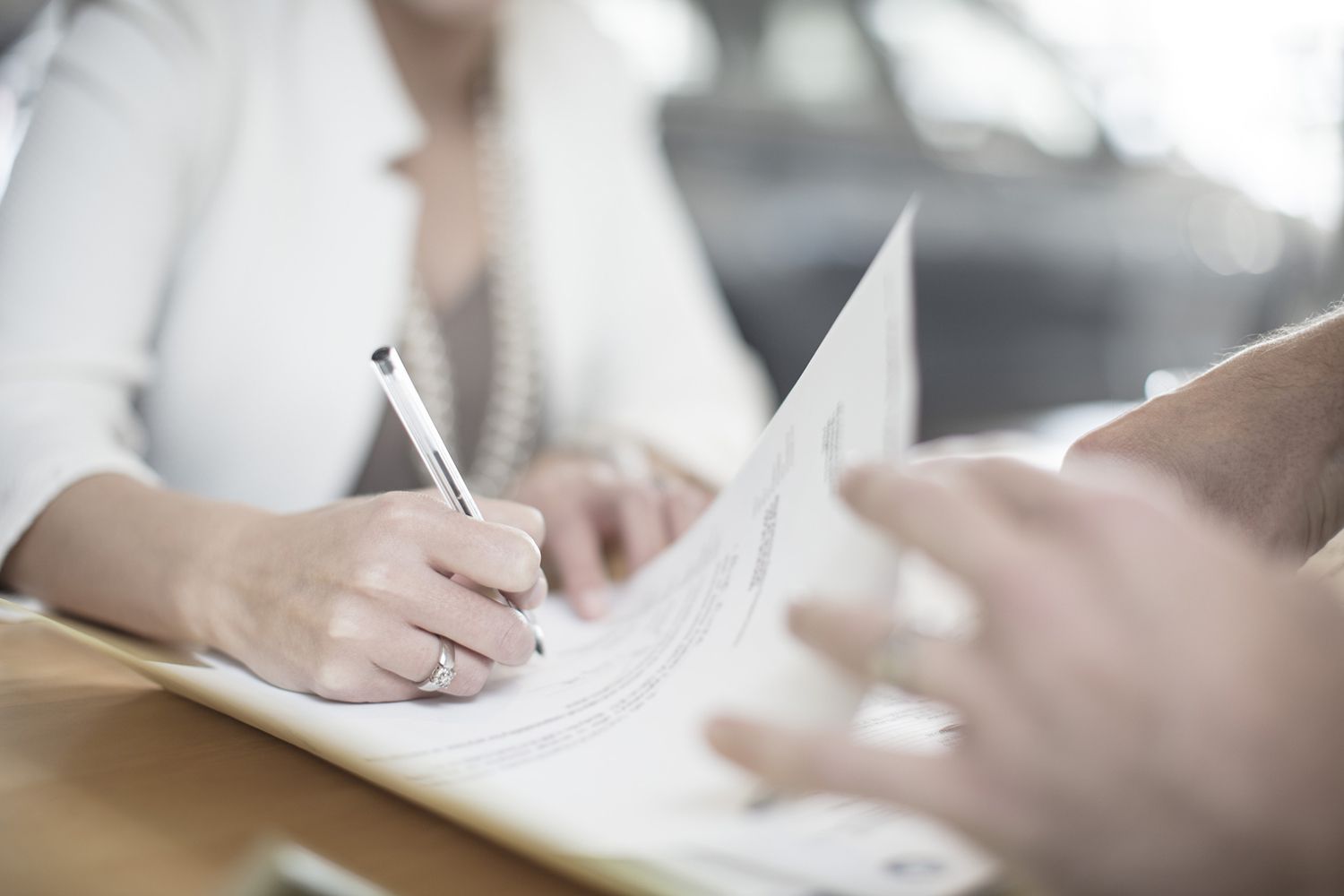 Signing Contract at Desk at Car Dealership