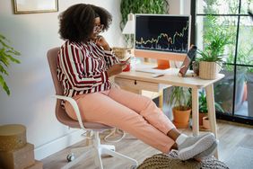 Woman entrepreneur analysing a cryptocurrency market graph at home office