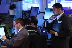 Traders work on the floor of the New York Stock Exchange during morning trading on May 27, 2025 in New York City. 