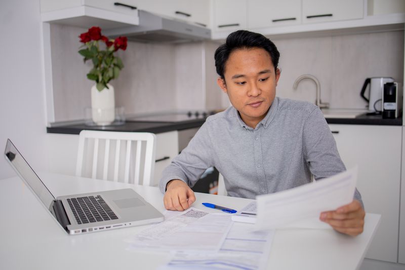 Person doing their taxes at their kitchen table