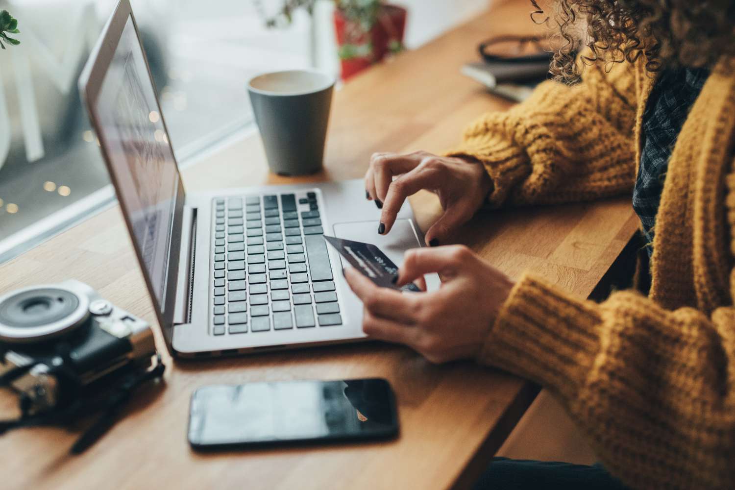 A shopper uses a laptop to enter a transaction authentication number for the credit card they are using for the online purchase.