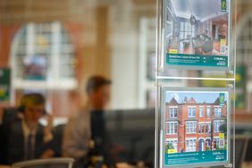 Property listings appear in the the window of a real estate agent's office in London