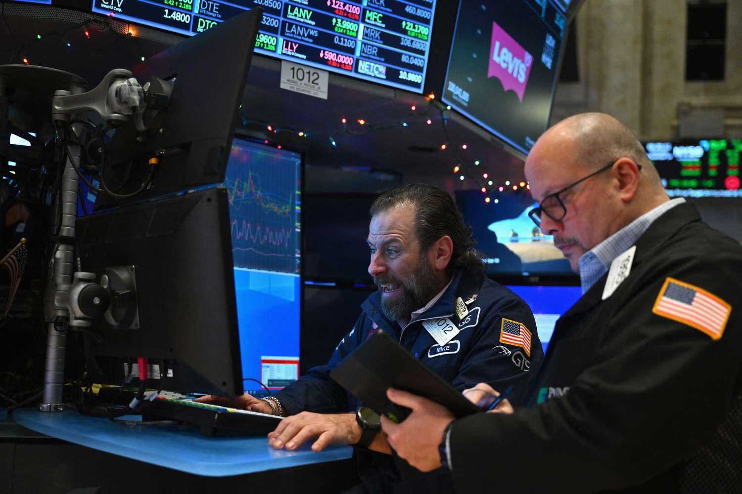 Traders work on the floor of the New York Stock Exchange (NYSE) during morning trading on December 14, 2023, in New York City.