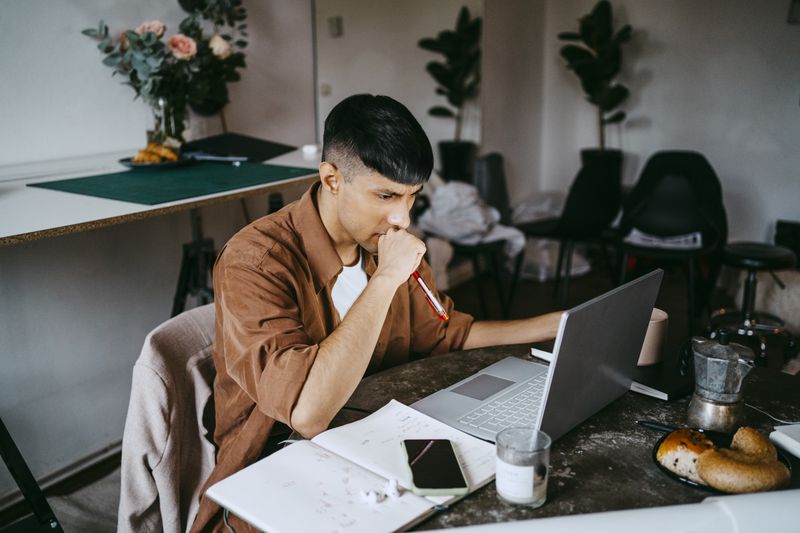 A worker with a laptop in an office