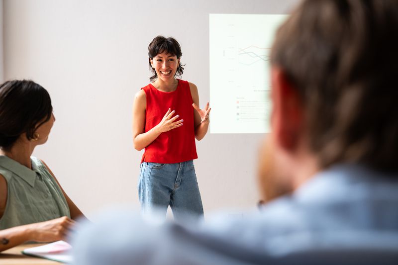 Young woman making a presentation in the meeting room.